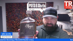Jake Jacoby holding El Mayor Extra Añejo during Ep. 12 of the POTS & SHOTS Podcast on becoming a telecom reseller
